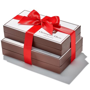 Essential Holiday Gift Tower tied with red ribbon
